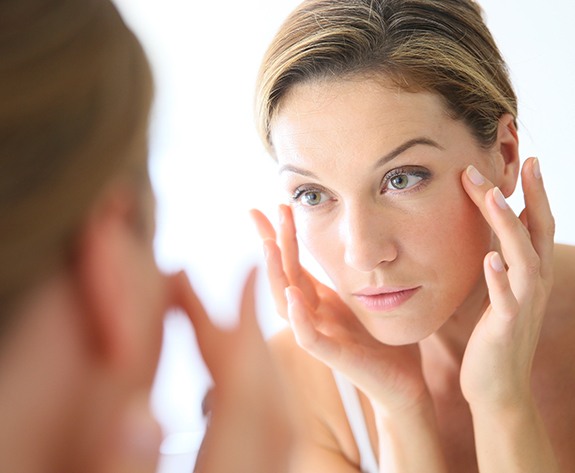 Woman examining her skin after Botox