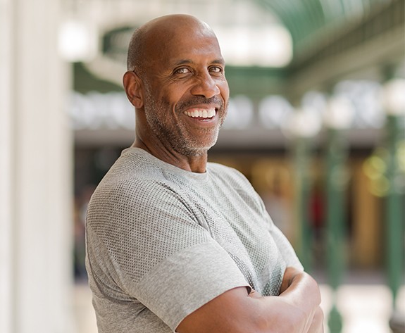 Man with dental crown restoration smiling