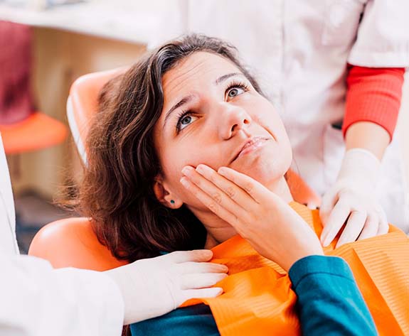 woman with toothache visiting her Greensboro emergency dentist