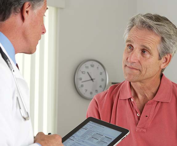 dentist and patient discussing the cost of dental emergencies in Greensboro