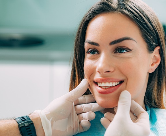 Dentist examining a patient's smile after tooth extraction