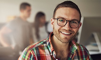 Man smiling after multiple tooth extractions