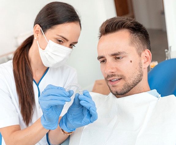 Man at dentist getting Invisalign in Greensboro