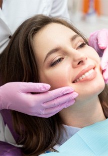 patient smiling in dental mirror 