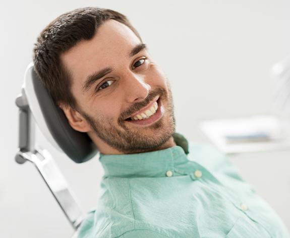 Man smiling during preventive dental checkup and teeth cleaning visit