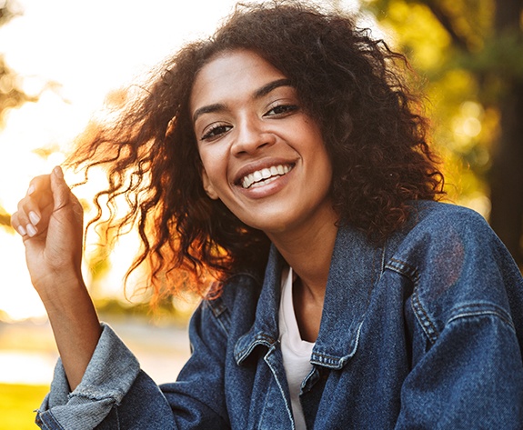 Woman sharing healthy smile after receiving an alternative to braces