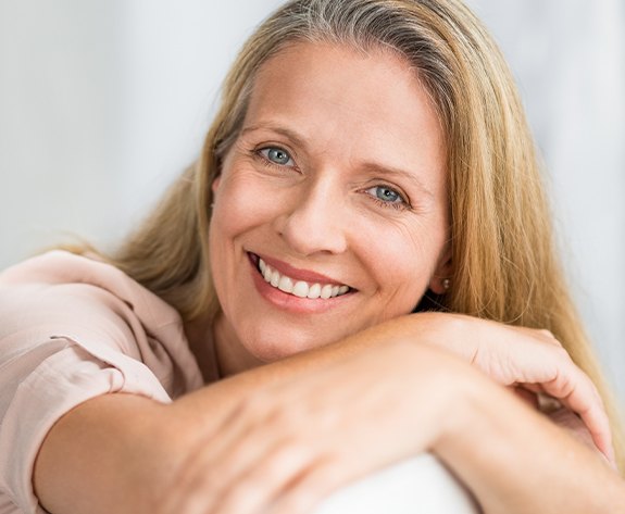 Woman with dental bridge restoration smiling