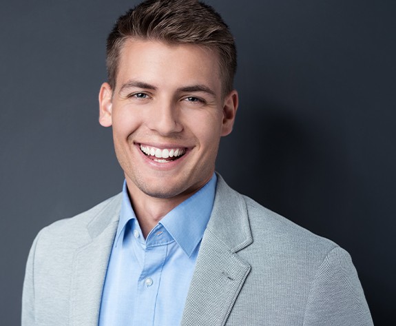 Man with healthy smile after tooth colored filling treatment