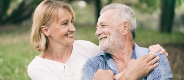 Man and woman smiling after restorative dentistry