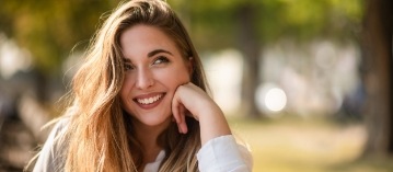 Young woman with beautiful smile after rapid orthodontics treatment