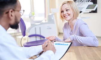 a patient discussing the cost of veneers with a dentist