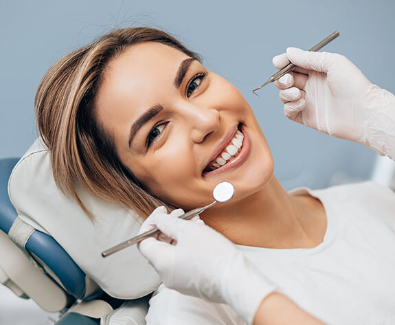 Woman smiling during dental appointment