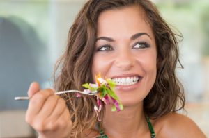 person eating greens