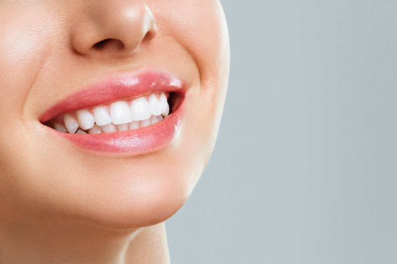 woman flashing a very white smile.