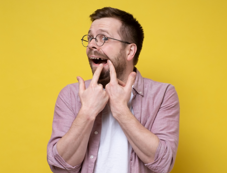 Man pointing at missing tooth