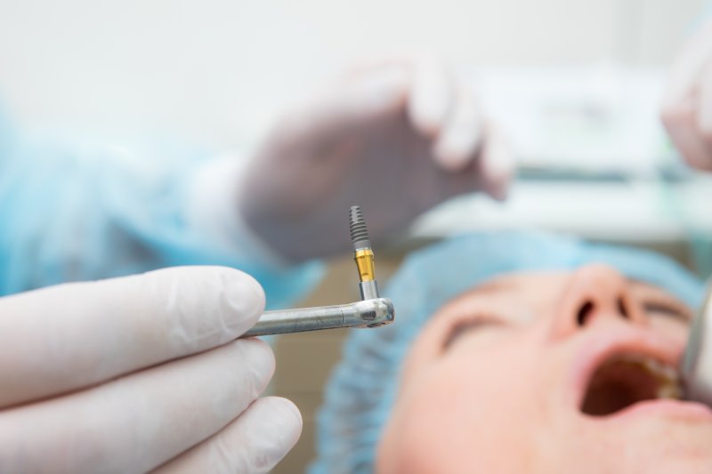 A surgeon performing dental implant surgery